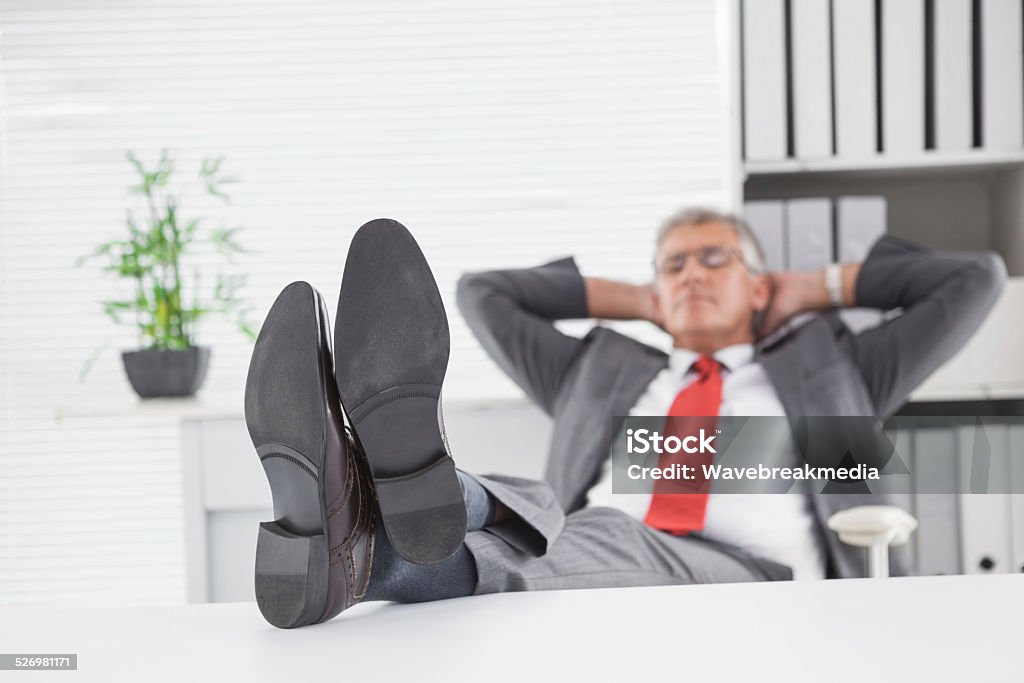 Relaxed businessman with his feet up Relaxed businessman with his feet up in his office 50-54 Years Stock Photo