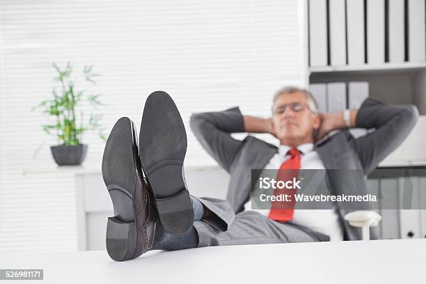 Relaxed Businessman With His Feet Up Stock Photo - Download Image Now - 50-54 Years, 50-59 Years, Adult