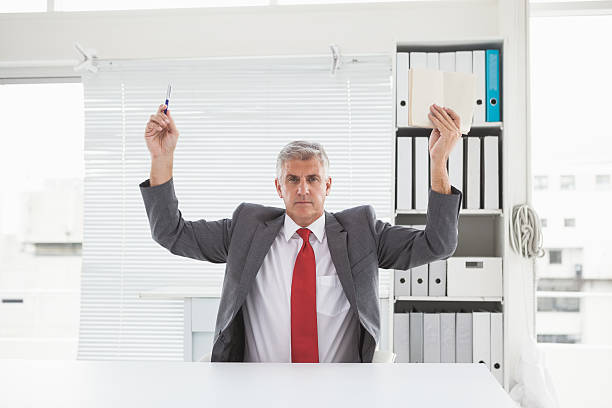 istock Mature businessman holding pen and book 526981225