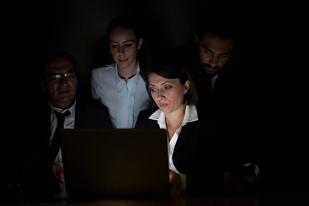 istock Teamwork. Businessman to the PC in the dark room 526981809