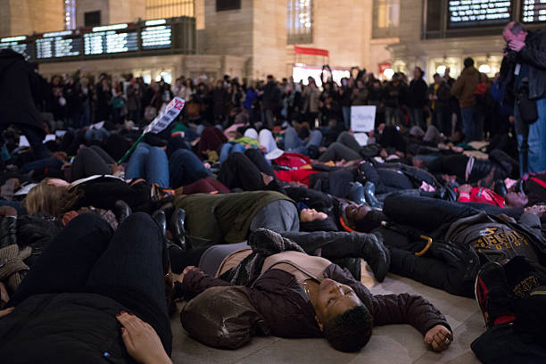 Eric Garner Protestors Lie on Floor of Grand Central Terminal New York City, USA - December 6, 2014: Demonstrators Lie on Floor of Grand Central Terminal to protest the deaths of Eric Garner and Michael Brown and the acquittals of the police officers who killed them. Chants of "I can't breathe" and "Hands Up, Don't Shoot!" where heard. i cant breathe stock pictures, royalty-free photos & images