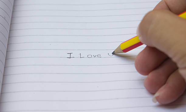 istock male write I love u on paper 527011125