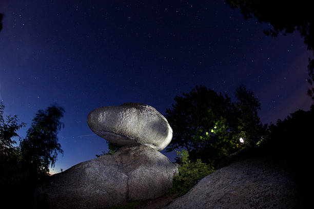 Magic Rock in Austria,  night shot, lightend silhouette against the sky with stars, power place in Austria, Mühlviertel