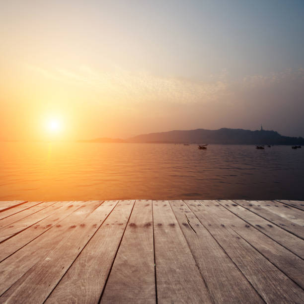 istock plank board with lake in sunset as background 527012121