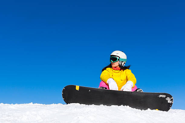 istock snowboarder sitting snow mountain slope copy space 527013765