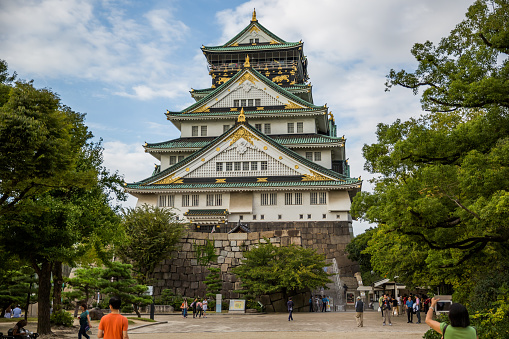 Osaka, Japan - September 26, 2014: Osaka Castle, Osaka, Japan.Lots of visitors in the surrounding park and on the stairs leading to the castle.