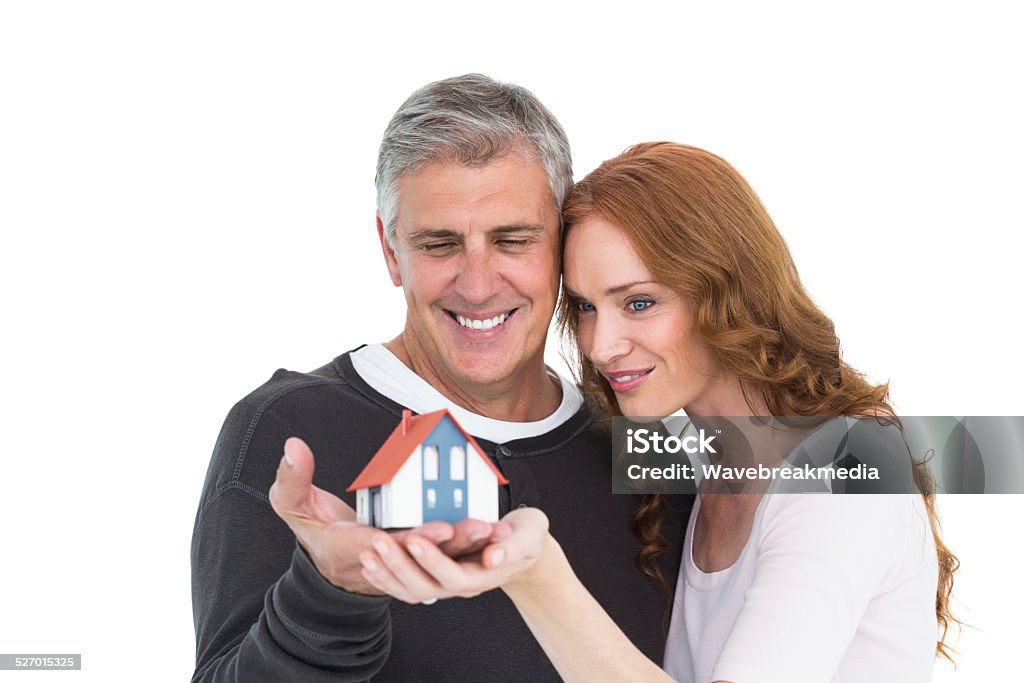 Casual couple holding small house Casual couple holding small house on white background 30-39 Years Stock Photo