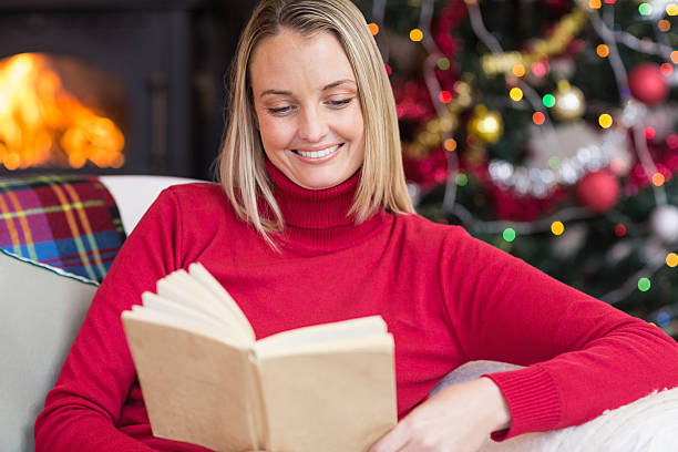 istock Pretty blonde reading book at christmas time 527016037