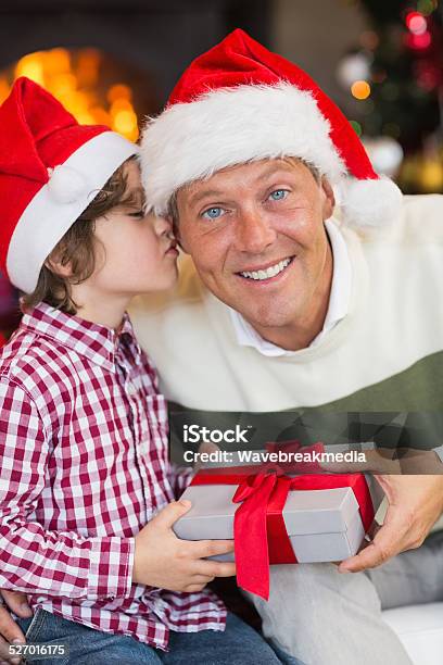 Son Kissing His Father After Receiving A Christmas Gift Stock Photo - Download Image Now