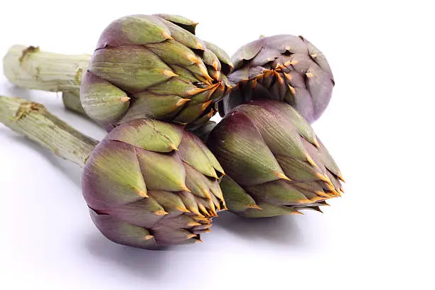 Raw spiny artichokes isolated on white background