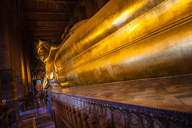 istock Golden reclining buddha statue 527027035