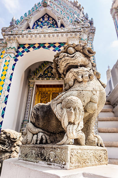 Chinese Lion statue Chinese dog or lion sculpture in Wat Phra Kaew, Temple of the Emerald Buddha, Bangkok, Thailand. chinese temple dog stock pictures, royalty-free photos & images