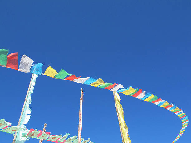 istock tibetan flags with mantra on sky background 527027924