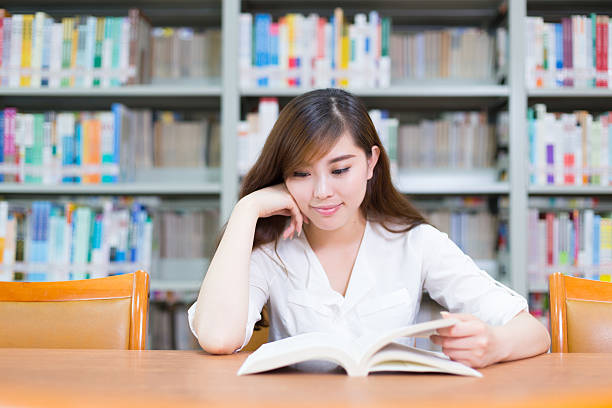istock young beautiful asian girl in school library 527028134