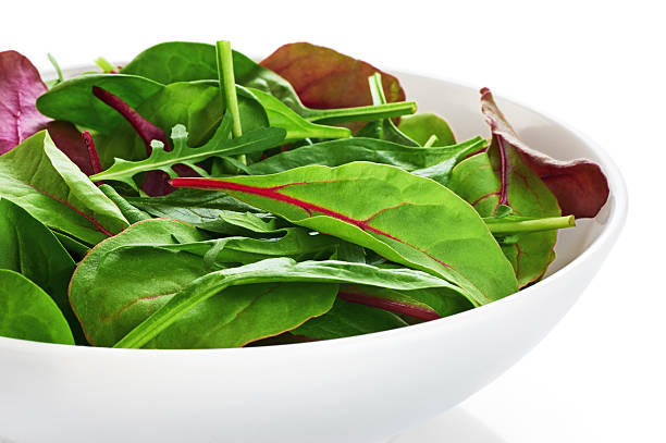 istock Bowl with fresh green salad isolated on white background. 527028472