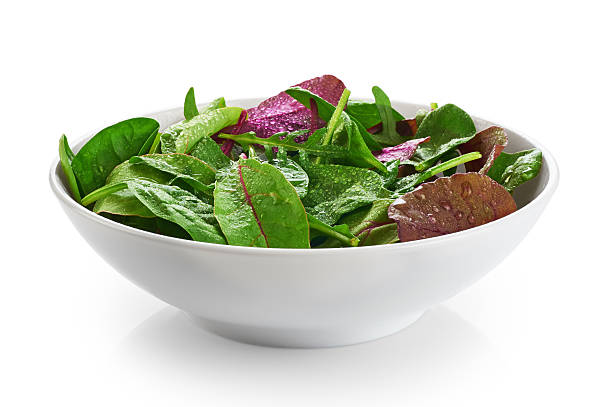 istock Bowl with fresh green salad isolated on white background. 527028492