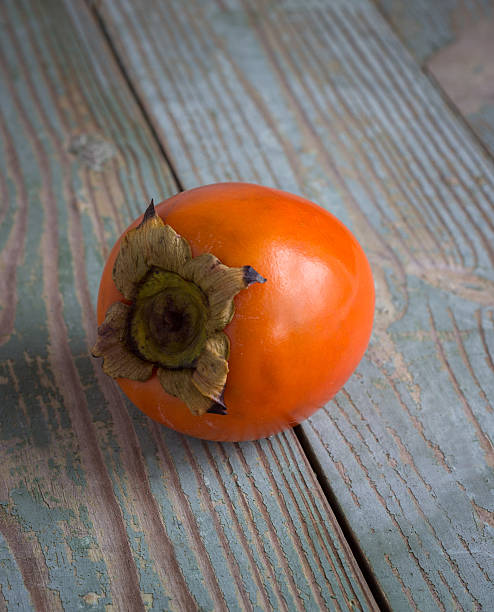 istock Persimmon on a wooden board 527029919