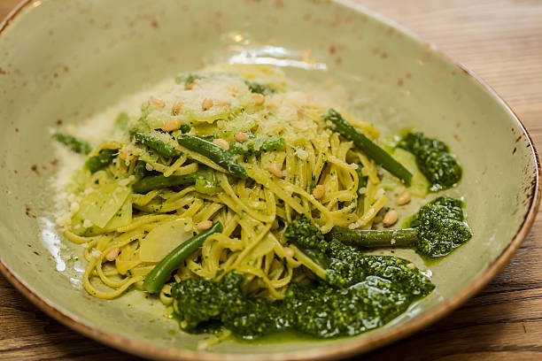 istock Italian pasta with pesto sauce close-up. 527032055