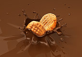 istock Two cookies biscuits falling into liquid chocolate splashing. 527033640