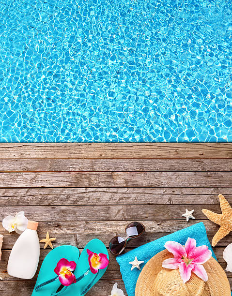 istock Beach accessories on wooden background with pool 527033698