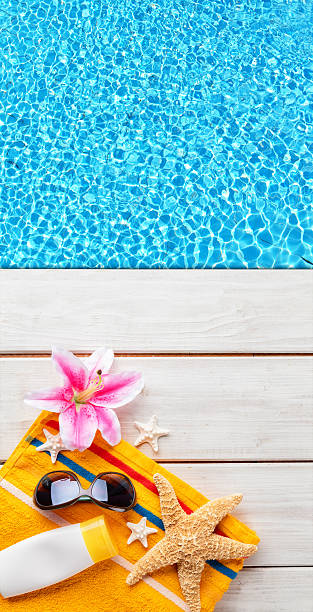 istock Beach accessories on wooden background with pool 527033758