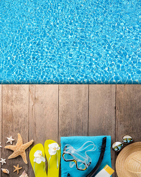 istock Beach accessories on wooden background with pool 527033888