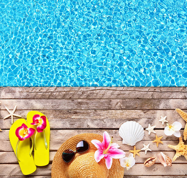istock Beach accessories on wooden background with pool 527034082