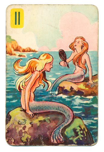 This is a Peter Pan playing card from British manufacturer Pepys with an illustration dating from 1939. Originally issued with green backs, this card is from a 1950s re-issue with red backs. The illustration shows two mermaids sitting on rocks.