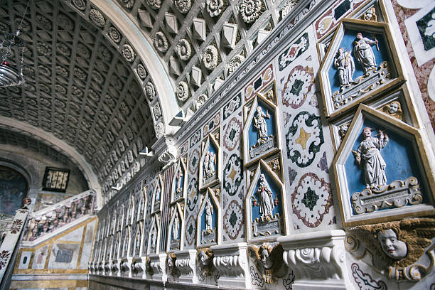 Close view of Baroque detail in Mdina, Malta shows gilded scrollwork, marble columns, tall white candles, and carved motifs under warm light inside a historic chapel.