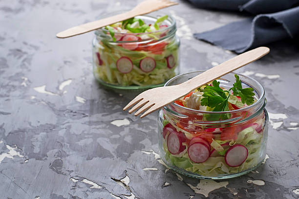 istock Salad with cabbage, radish and feta in jar 527035824
