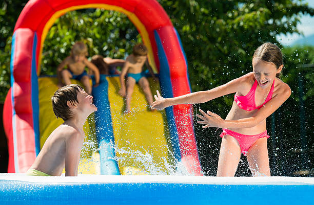 istock Kids Having Fun In Swimming Pool 527038602