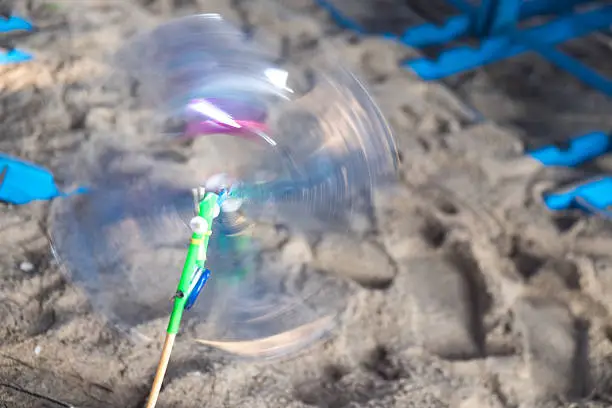 colorful toy moving whirlygig on beach