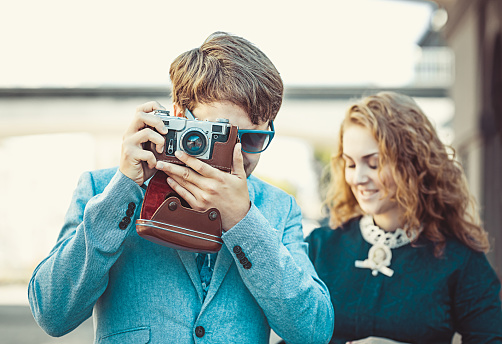 Hipster man wants to take a picture using your vintage camera