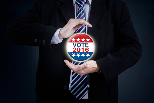 Businessperson hands giving a protection on the vote symbol with number 2016