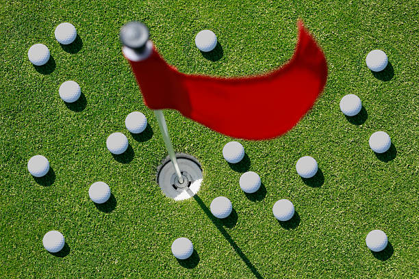 bolas de golfe na verde com bandeira vermelha. - golf flag putting green sport - fotografias e filmes do acervo