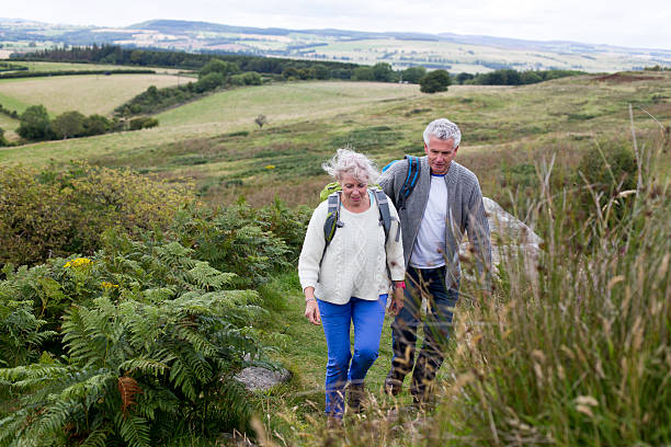 istock Happy Couple Walking Through the Countryside 527045596