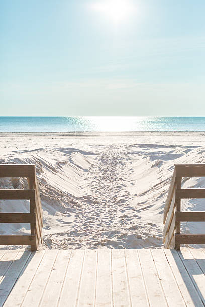 Wooden path goes to the beach. Sunny day on the beach without people