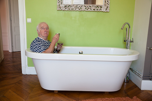 senior male surprised in bath in bedroom