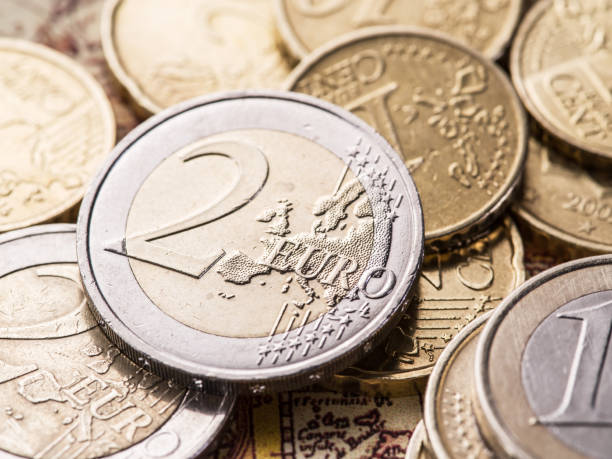 istock Euro coins over the old world map. 527046984
