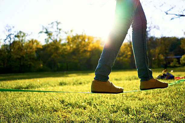 femme marchant sur une slackline - wasting time flash photos et images de collection