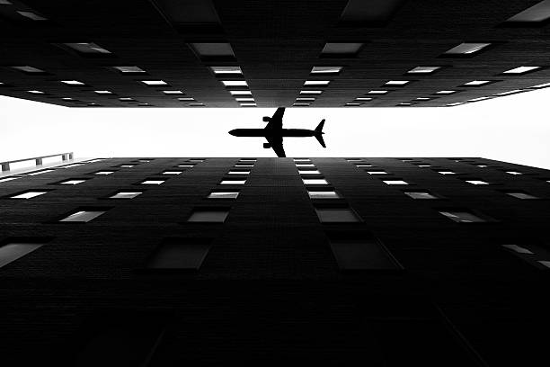 plane silhouette with skyscrapers stock photo