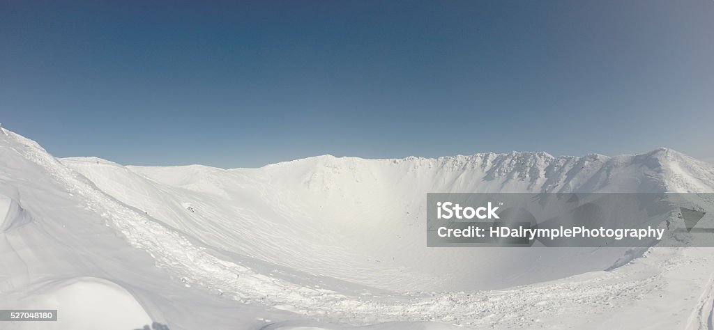 Mt. Yotei Crater The crater of Mt. Yotei while covered in snow. This volcano towers over the region in Hokkaido and is a popular hike for skiers and adventurers alike. Horizontal Stock Photo