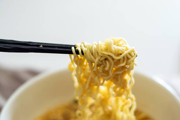 istock Black wooden chopsticks and noodles. 527048358