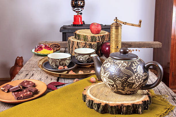 istock cups of tea on old wooden table, with apples 527048429
