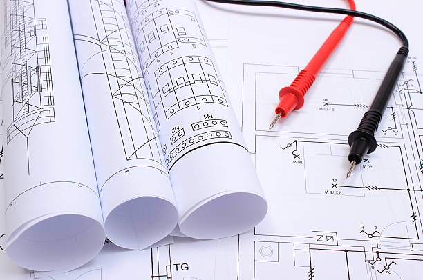 istock Rolled electrical diagrams and cables of multimeter on drawing 527048485