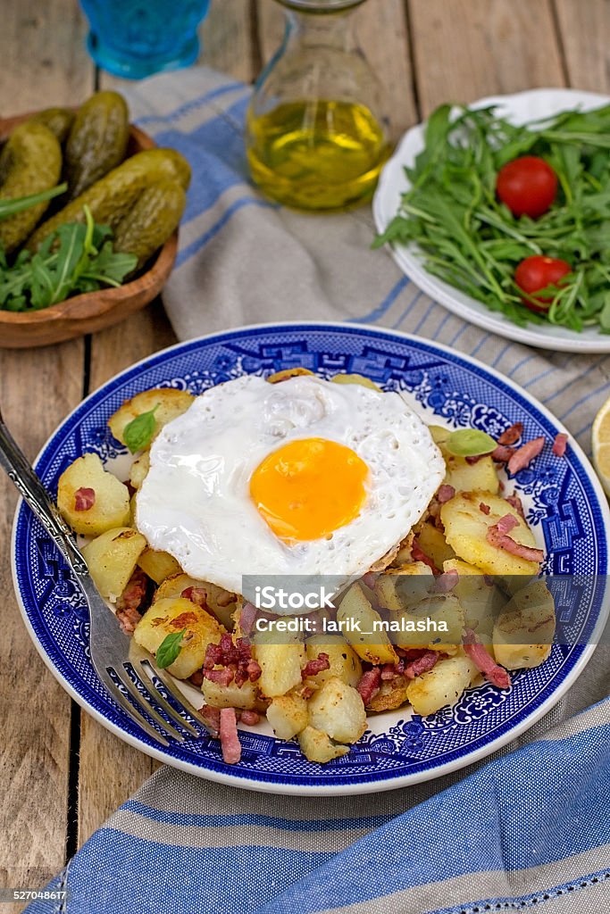 Roasted potatoes with bacon and eggs German style roasted potatoes with bacon and eggs Bacon Stock Photo