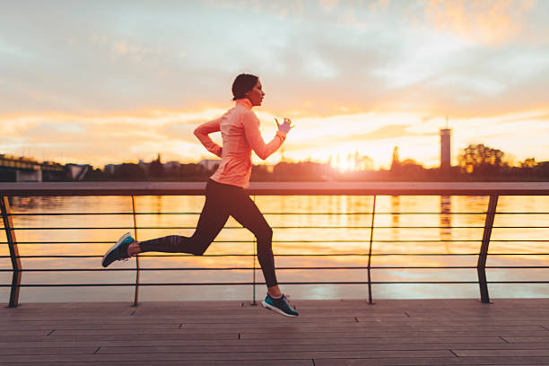 istock Young Woman Jogging Near River. 527049172