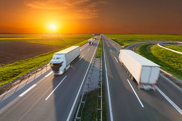 istock Delivery transport trucks on the empty highway at sunset 527049742