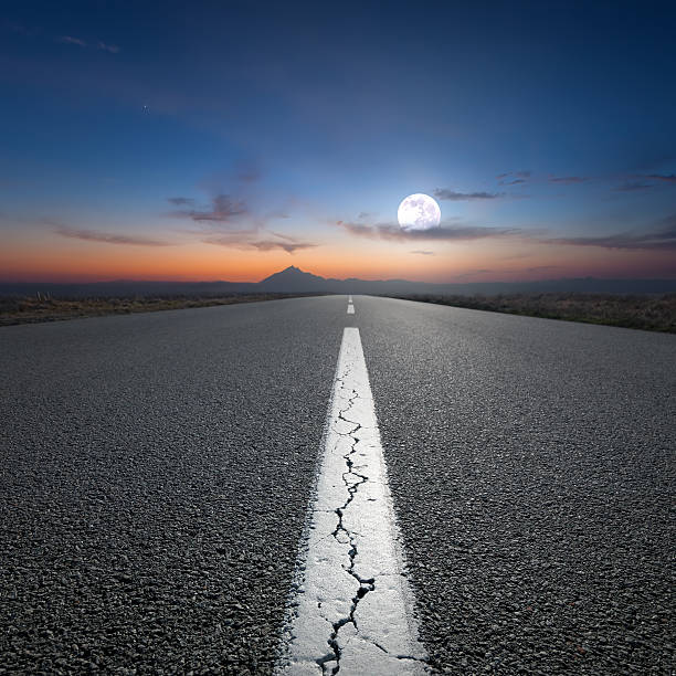 istock Driving on open road towards the mountain at dawn 527049888