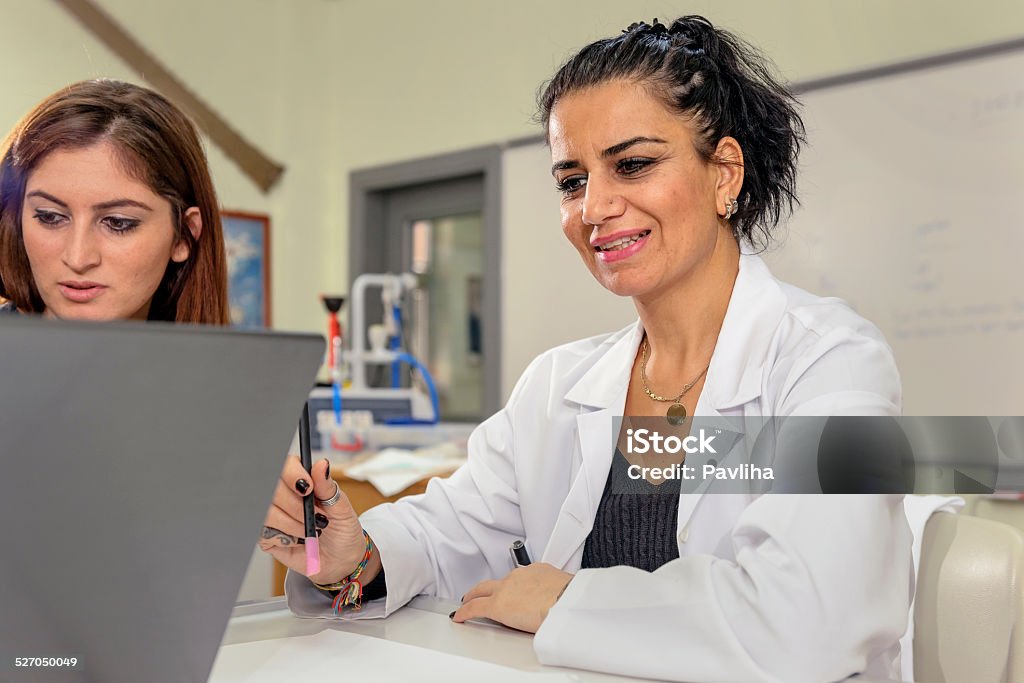 Turkish Teacher and student in Biology, Chemistry Lab Researching, Istanbul Good looking mature teacher at Istanbul secondary school, university, working in the biology, chemistry lab, Istanbul, Turkey. Nikon D Istanbul Stock Photo